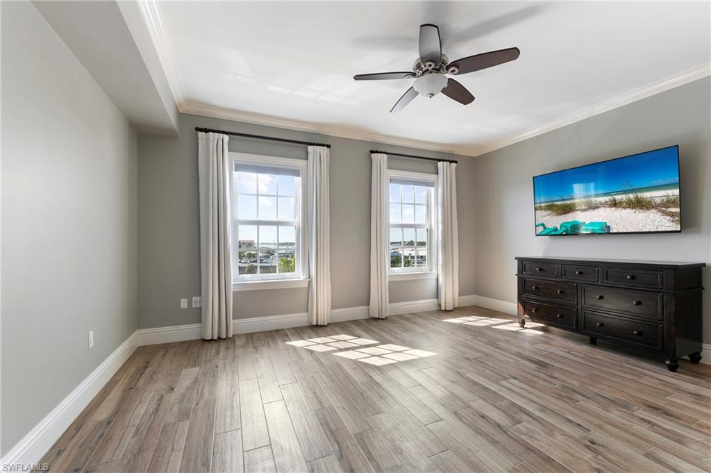 451 Bayfront Place, Unit 5407 Naples, FL 34102 - Photo 20 of 38 Unfurnished living room with light wood-style flooring, a ceiling fan, and ornamental molding