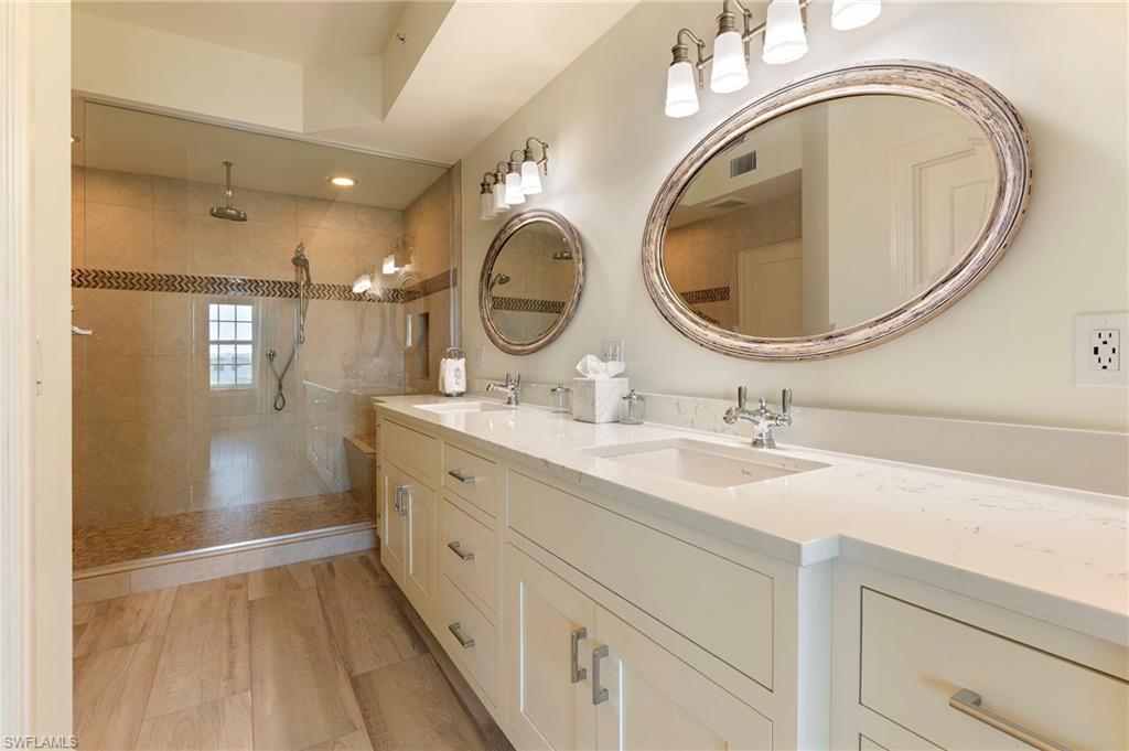451 Bayfront Place, Unit 5407 Naples, FL 34102 - Photo 21 of 38 Full bath with double vanity, walk in shower, and light wood finished floors