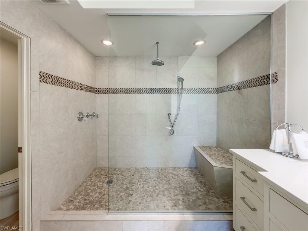 451 Bayfront Place, Unit 5407 Naples, FL 34102 - Photo 23 of 41 a bathroom with a shower and vanity