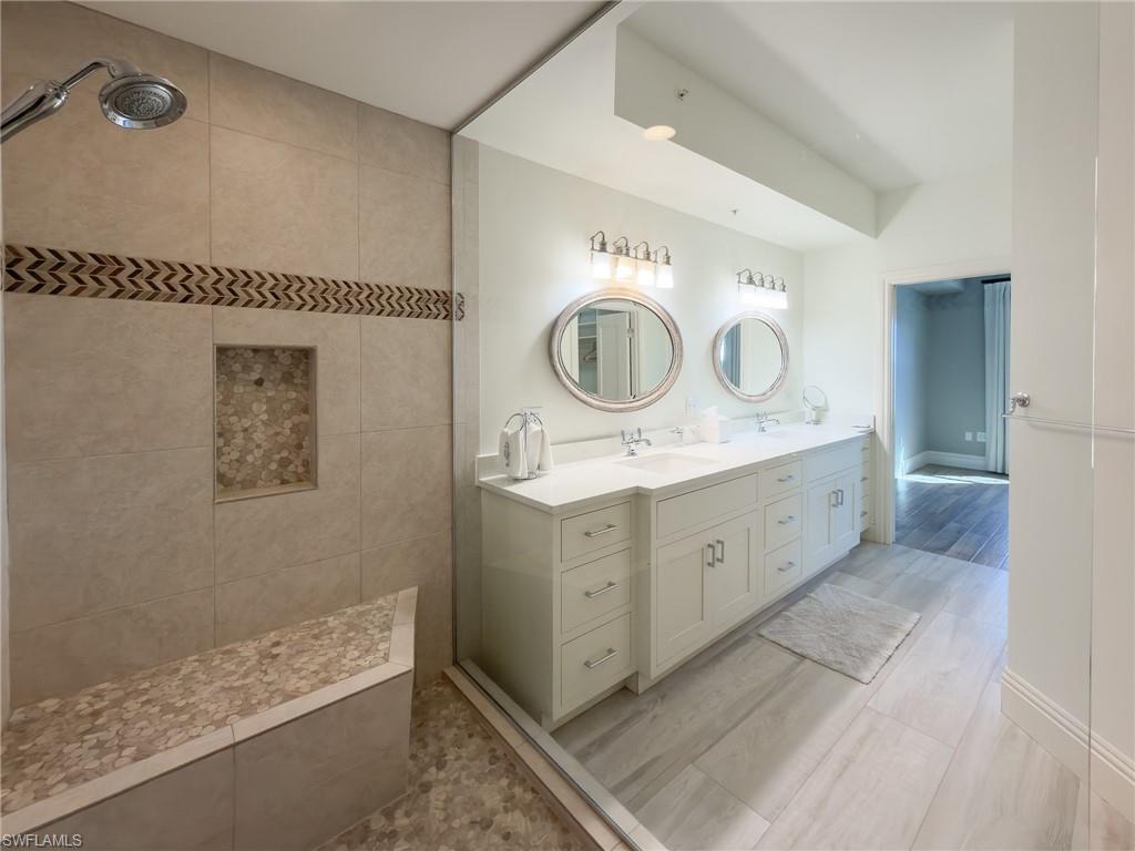 451 Bayfront Place, Unit 5407 Naples, FL 34102 - Photo 24 of 41 a spacious bathroom with a double vanity sink mirror and bathtub