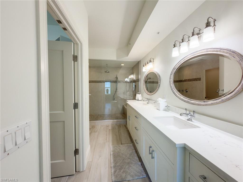 451 Bayfront Place, Unit 5407 Naples, FL 34102 - Photo 26 of 45 Bathroom featuring a tile shower and double vanity