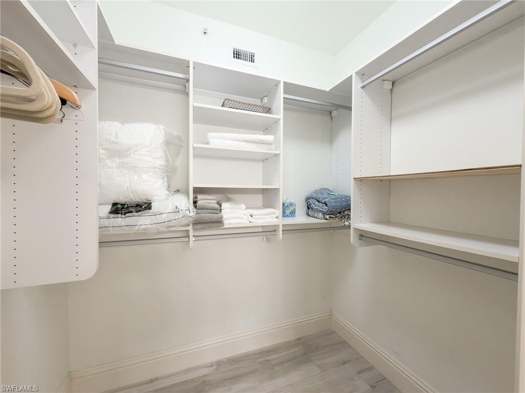 451 Bayfront Place, Unit 5407 Naples, FL 34102 - Photo 29 of 45 Walk in closet with light wood finished floors