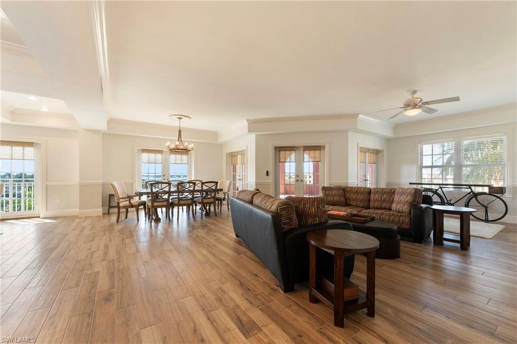 451 Bayfront Place, Unit 5407 Naples, FL 34102 - Photo 3 of 38 Living area featuring light wood-style flooring, french doors, ornamental molding, healthy amount of natural light, and ceiling fan