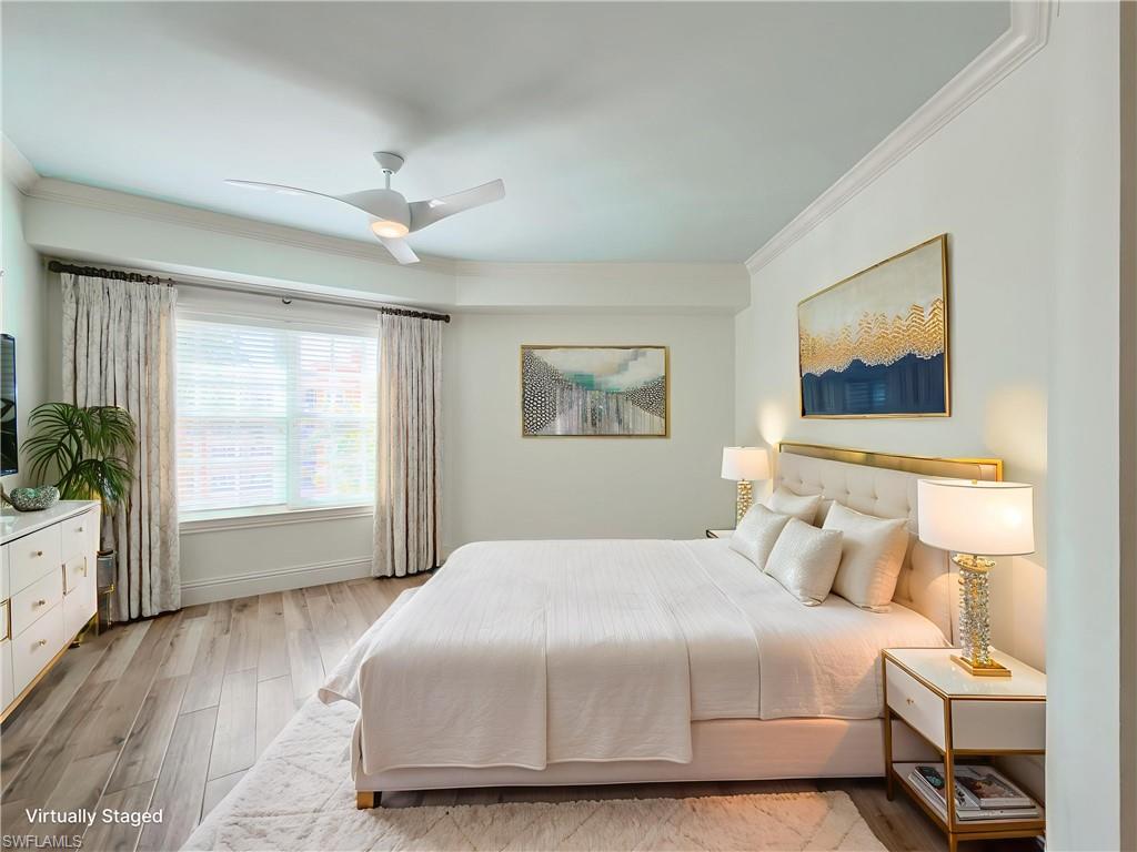 451 Bayfront Place, Unit 5407 Naples, FL 34102 - Photo 31 of 45 Bedroom featuring light wood-style floors, crown molding, and a ceiling fan
