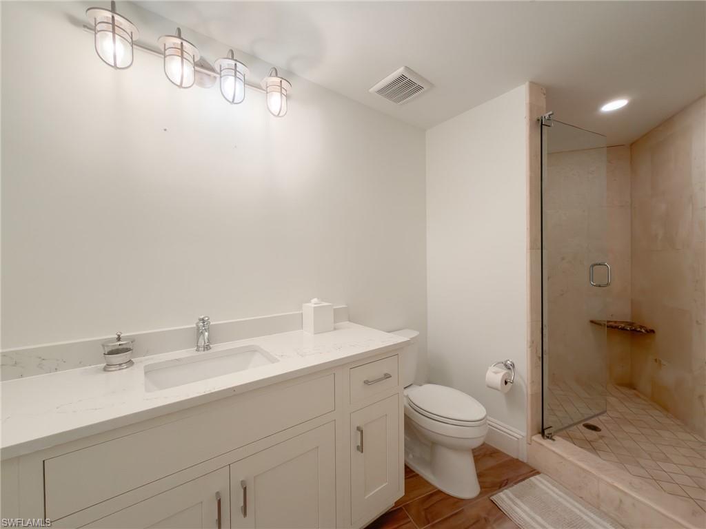 451 Bayfront Place, Unit 5407 Naples, FL 34102 - Photo 32 of 45 Bathroom with vanity, a shower stall, recessed lighting, and light wood finished floors