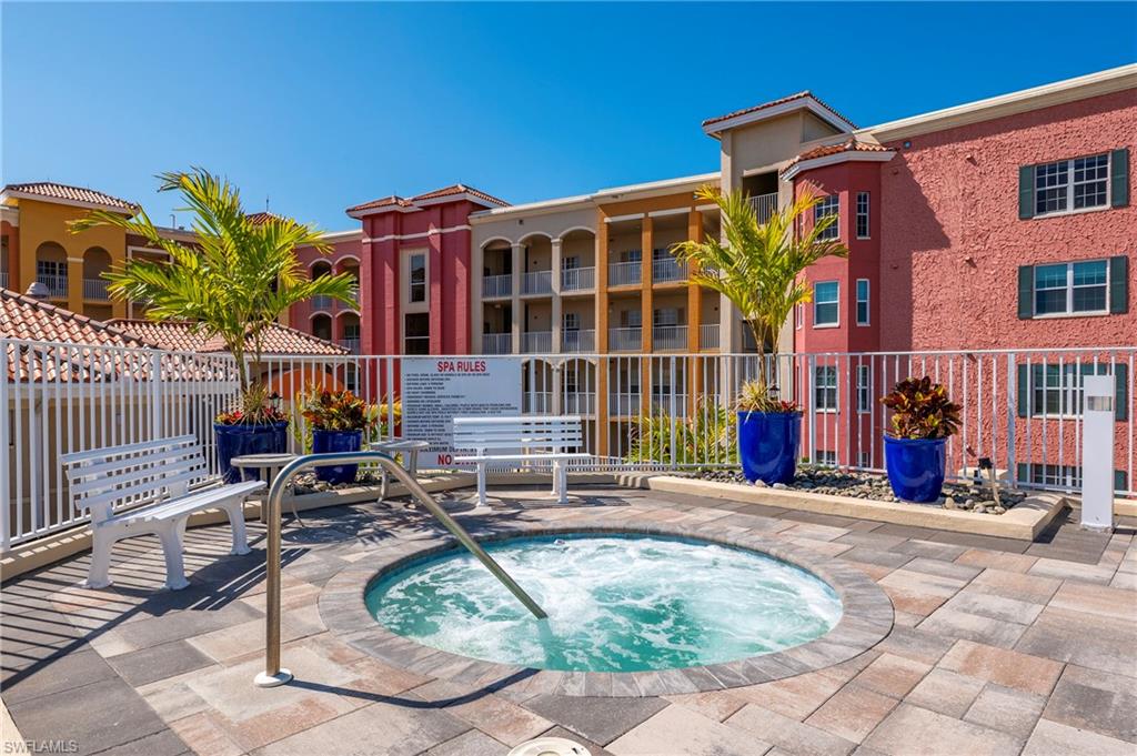 451 Bayfront Place, Unit 5407 Naples, FL 34102 - Photo 33 of 41 View of swimming pool with a community hot tub and patio surround