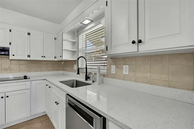 a kitchen with a sink and cabinets