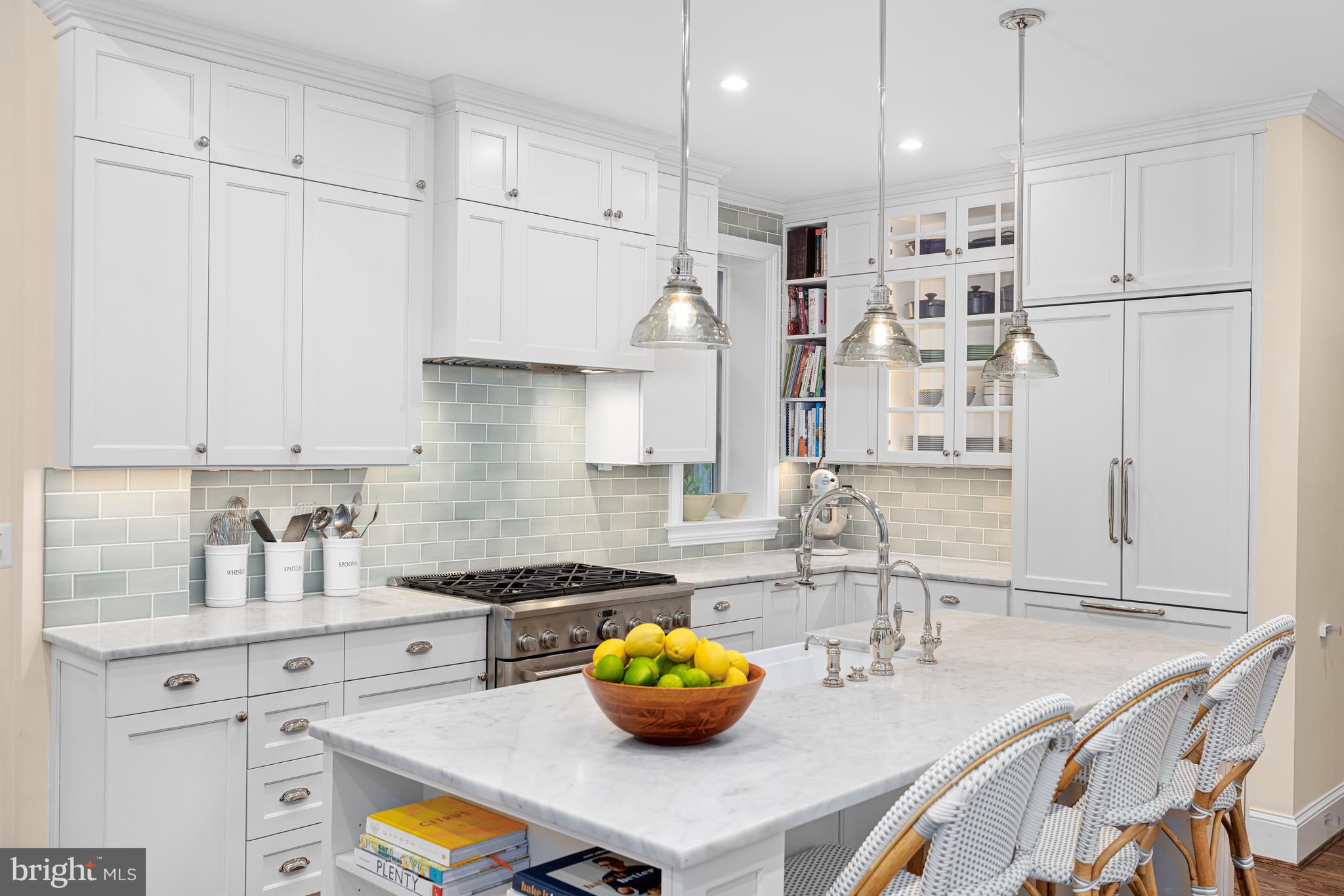 3013 Cathedral Avenue Northwest Washington, DC 20008 - Photo 13 of 33 a kitchen with kitchen island granite countertop a sink a stove and white cabinets