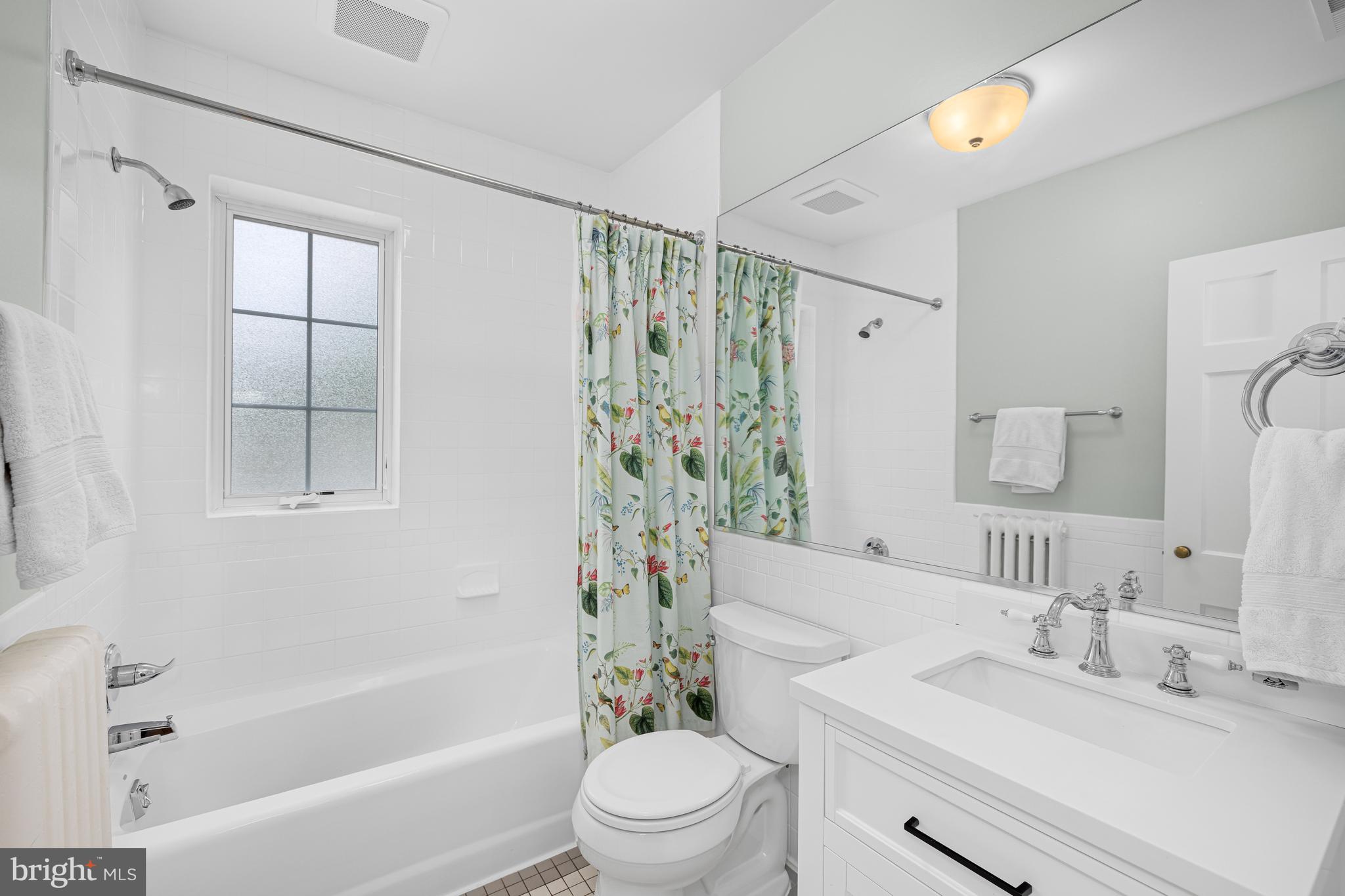 3013 Cathedral Avenue Northwest Washington, DC 20008 - Photo 25 of 33 a bathroom with a sink a toilet and a large mirror