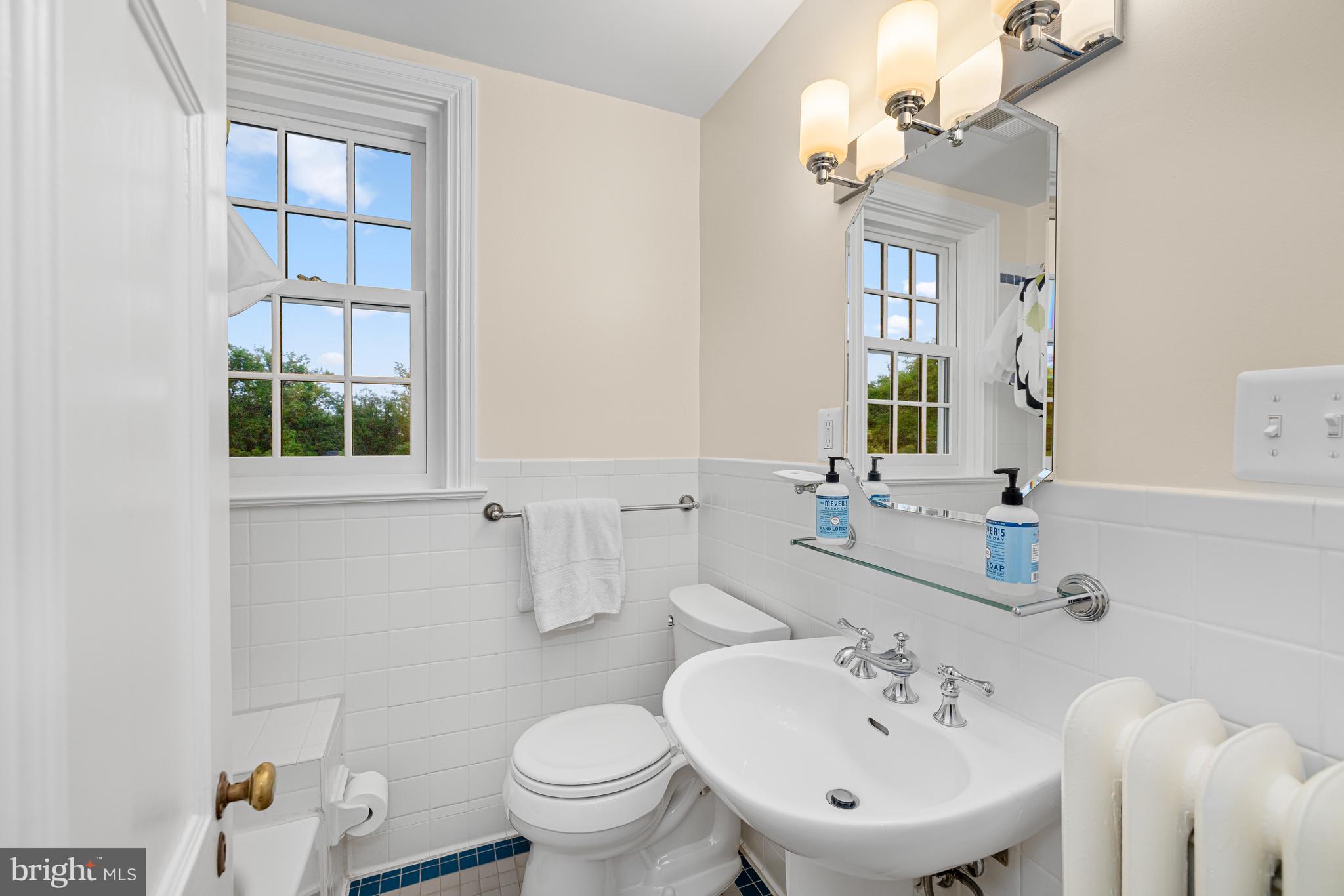 3013 Cathedral Avenue Northwest Washington, DC 20008 - Photo 30 of 33 a bathroom with a sink toilet and a mirror