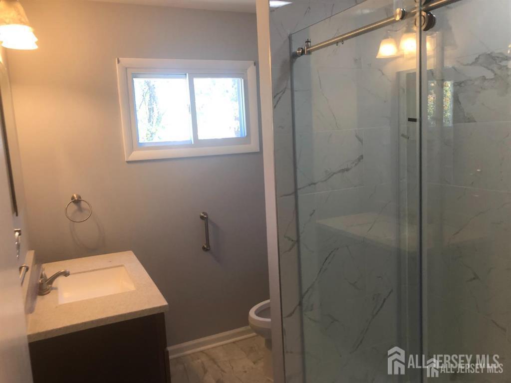 27 Mill Road Edison, NJ 08817 - Photo 12 of 17 a bathroom with a sink toilet and shower