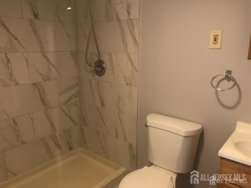 27 Mill Road Edison, NJ 08817 - Photo 13 of 17 a white toilet sitting next to a shower