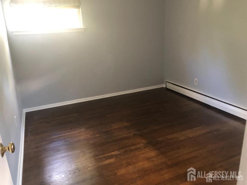 27 Mill Road Edison, NJ 08817 - Photo 8 of 17 a view of an empty room with wooden floor