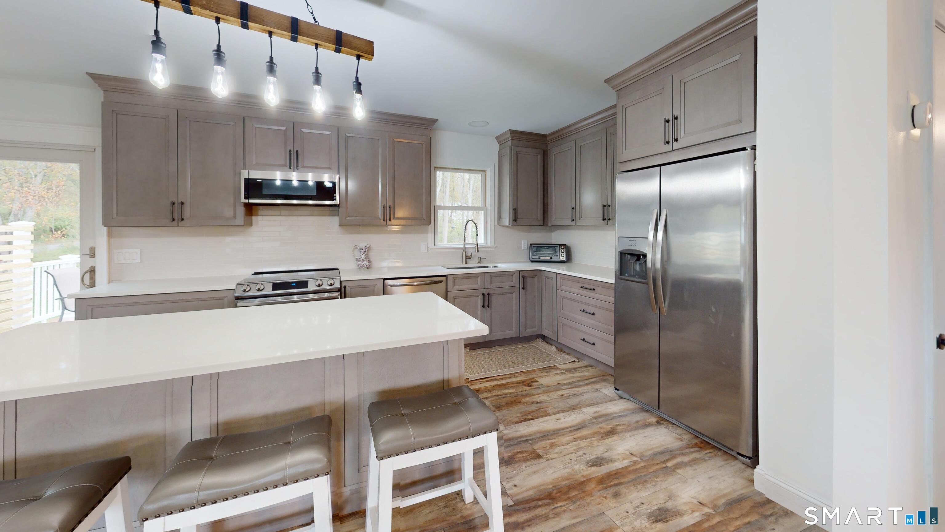 29 Deer Ridge Road Stonington, CT 06378 - Photo 4 of 35 a kitchen with stainless steel appliances a refrigerator sink and microwave