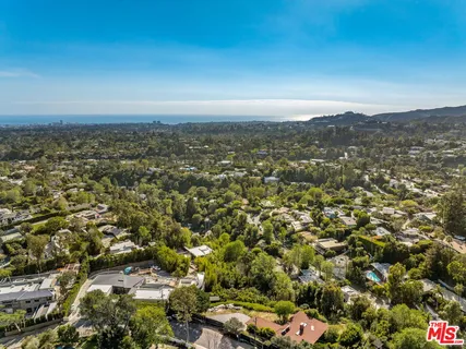 an aerial view of residential houses with city view