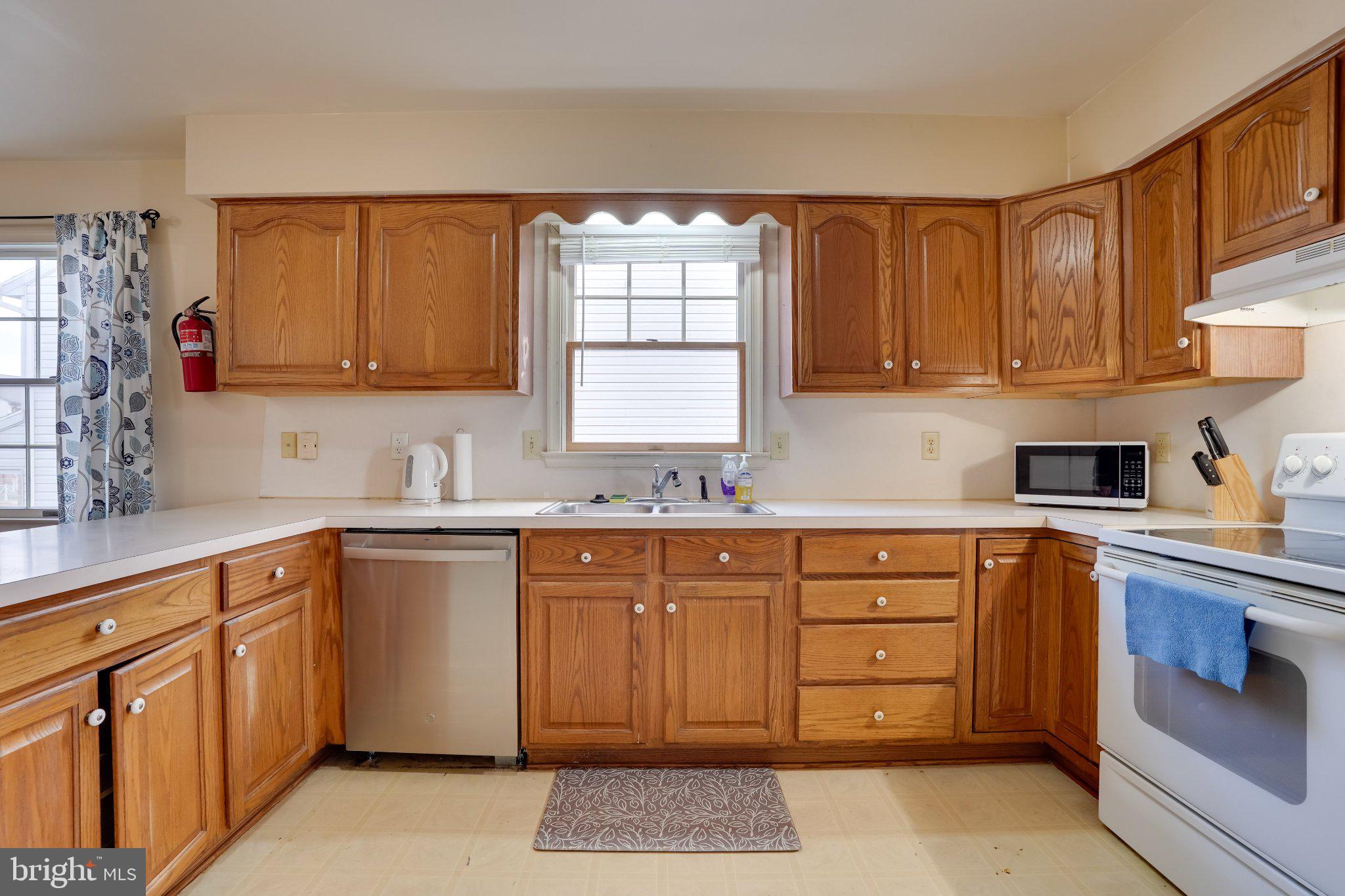 713-715 Medway Road Hagerstown, MD 21740 - Photo 18 of 43 a kitchen with cabinets appliances and a window