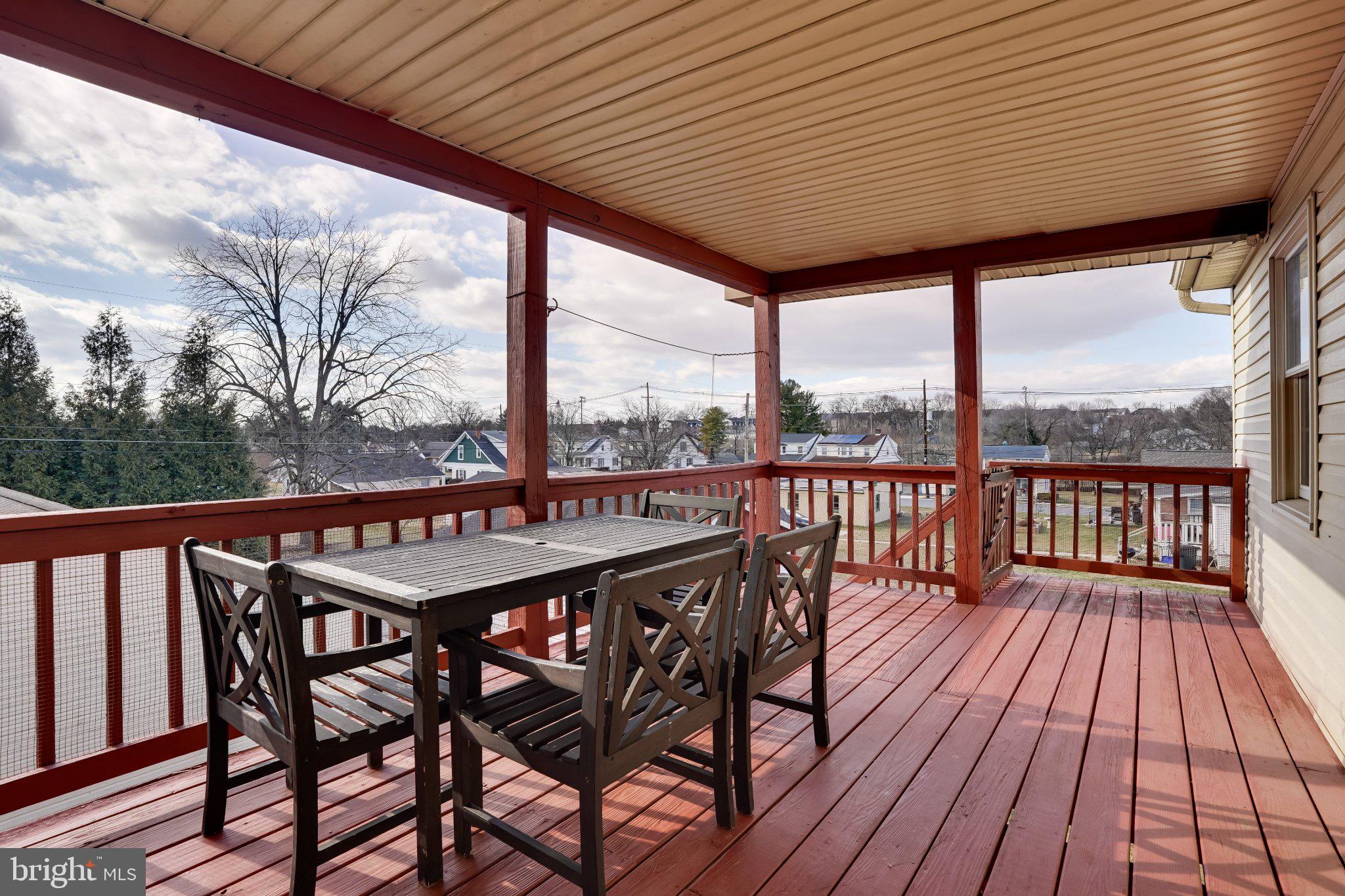713-715 Medway Road Hagerstown, MD 21740 - Photo 22 of 43 a view of a balcony with furniture and wooden floor