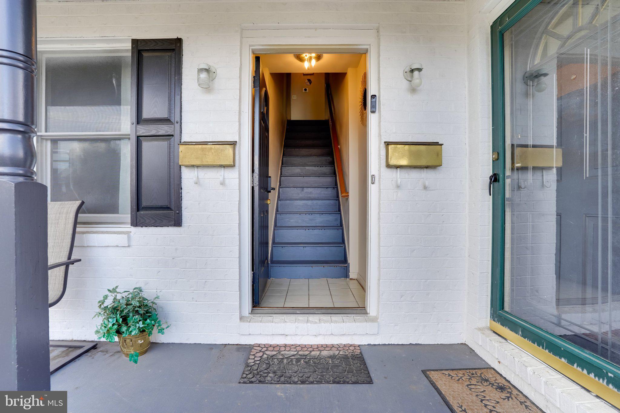 713-715 Medway Road Hagerstown, MD 21740 - Photo 3 of 43 a view of a hallway with wooden floor and a potted plant