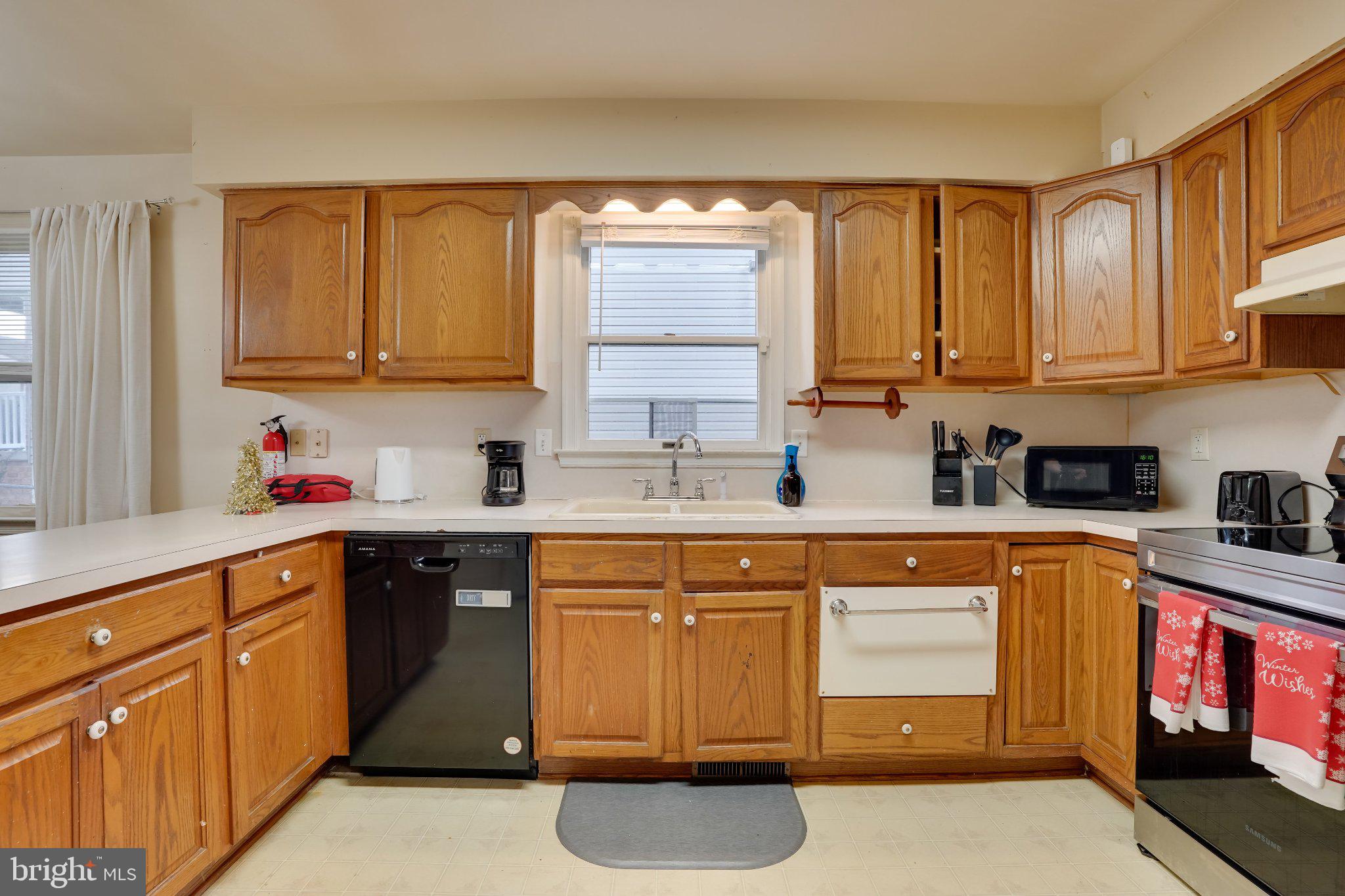 713-715 Medway Road Hagerstown, MD 21740 - Photo 39 of 43 a kitchen with cabinets appliances a sink and a window