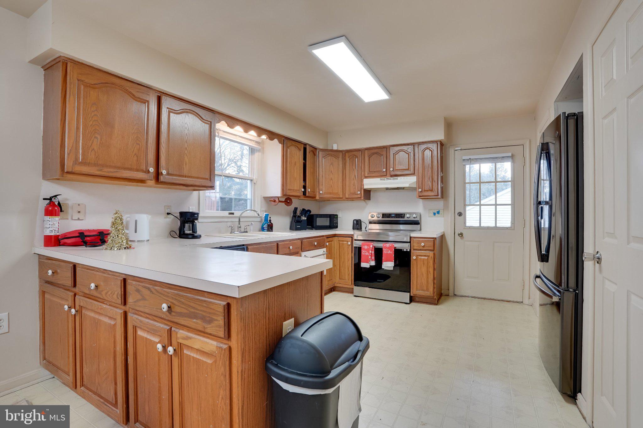 713-715 Medway Road Hagerstown, MD 21740 - Photo 40 of 43 a kitchen with granite countertop a stove sink and cabinets