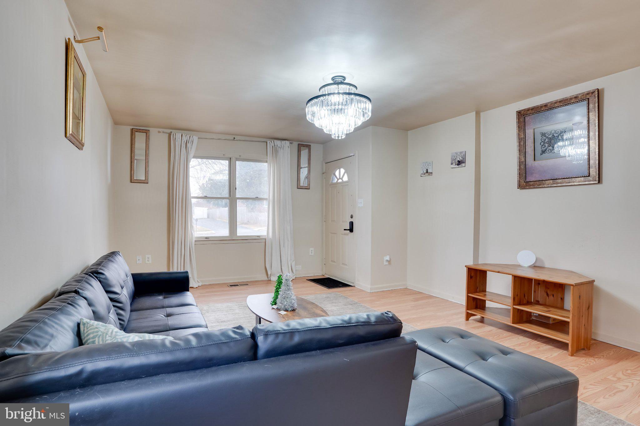713-715 Medway Road Hagerstown, MD 21740 - Photo 42 of 43 a living room with furniture a large window and a chandelier