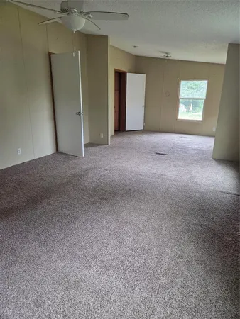 a view of an empty room and a window