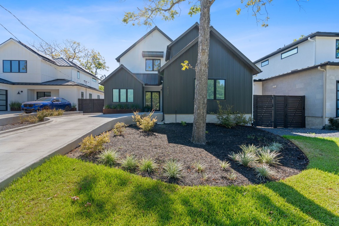 a front view of a house with a yard fire pit and outdoor seating