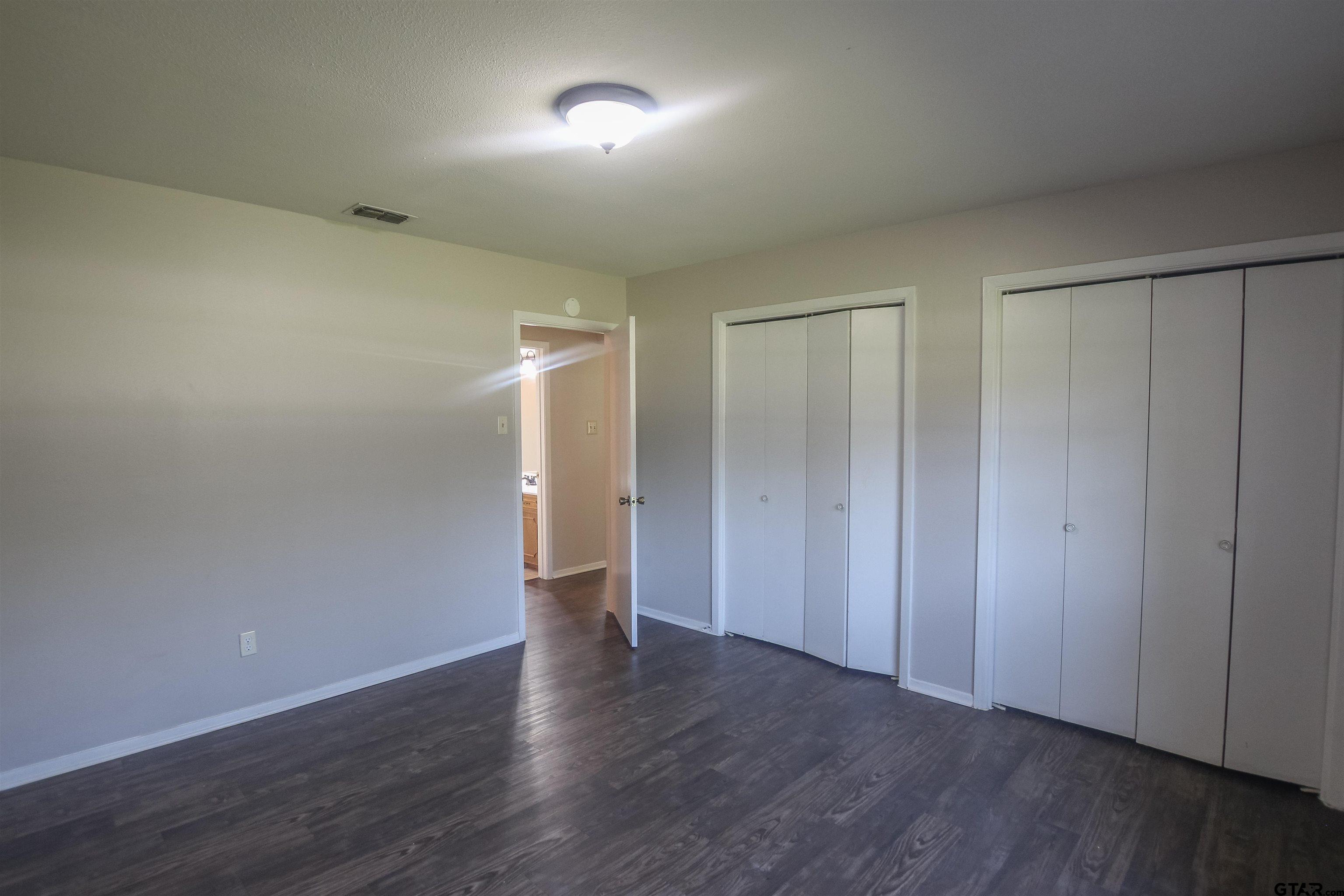 8524 Radcliffe Drive Tyler, TX 75703 - Photo 19 of 26 a view of an empty room with wooden floor