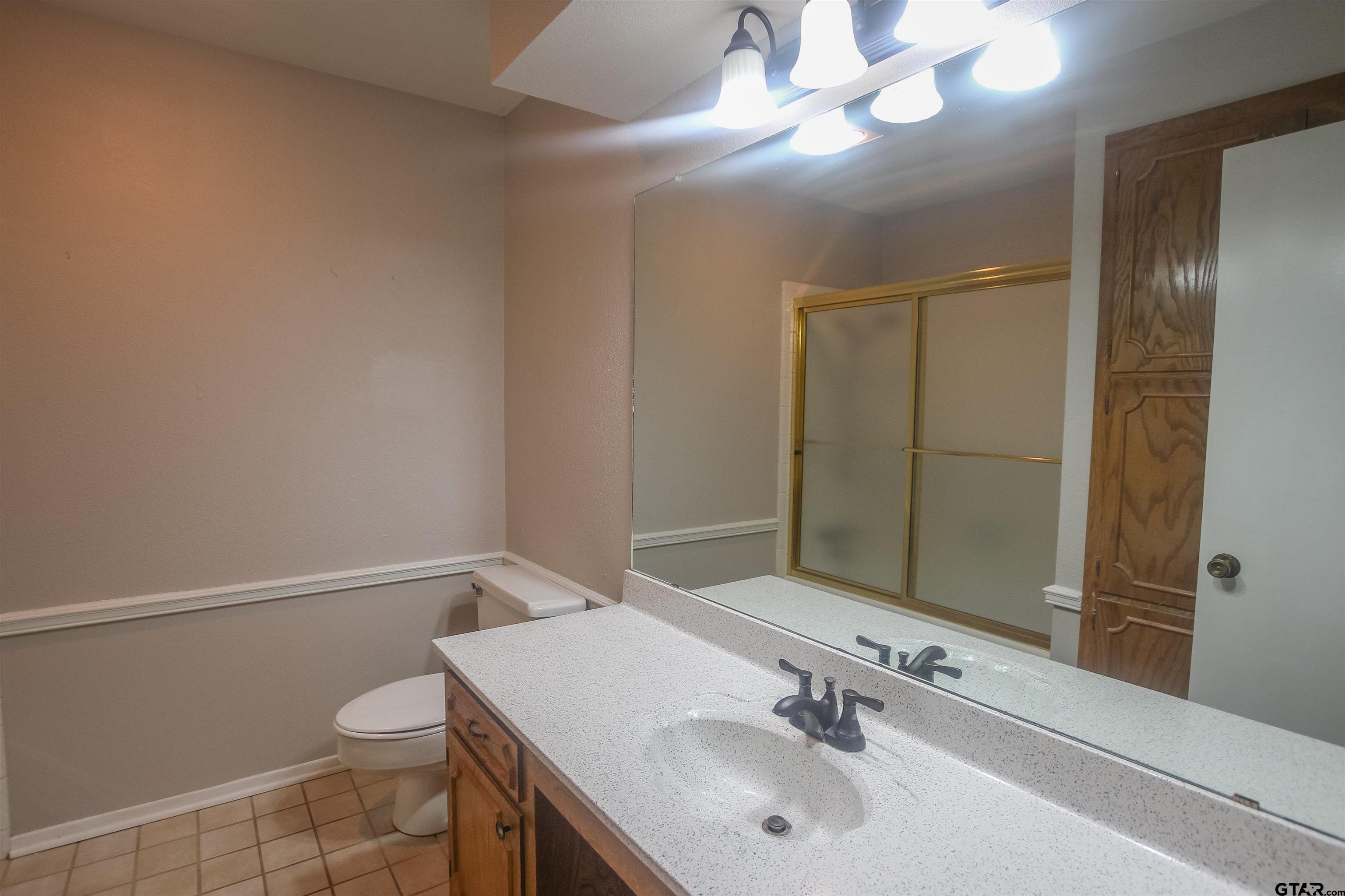 8524 Radcliffe Drive Tyler, TX 75703 - Photo 20 of 26 a bathroom with a sink vanity and toilet