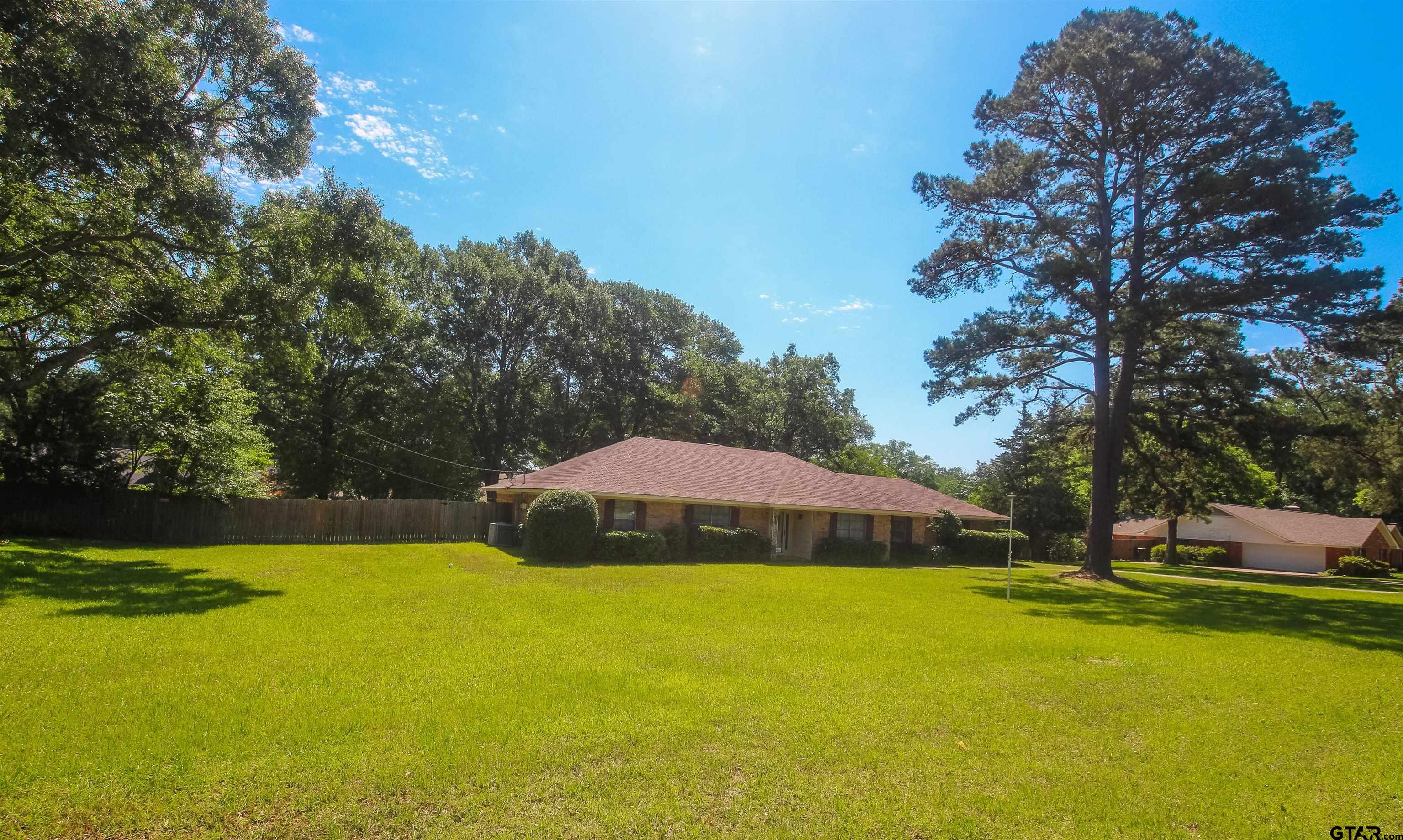 8524 Radcliffe Drive Tyler, TX 75703 - Photo 2 of 26 a view of a house with swimming pool and yard