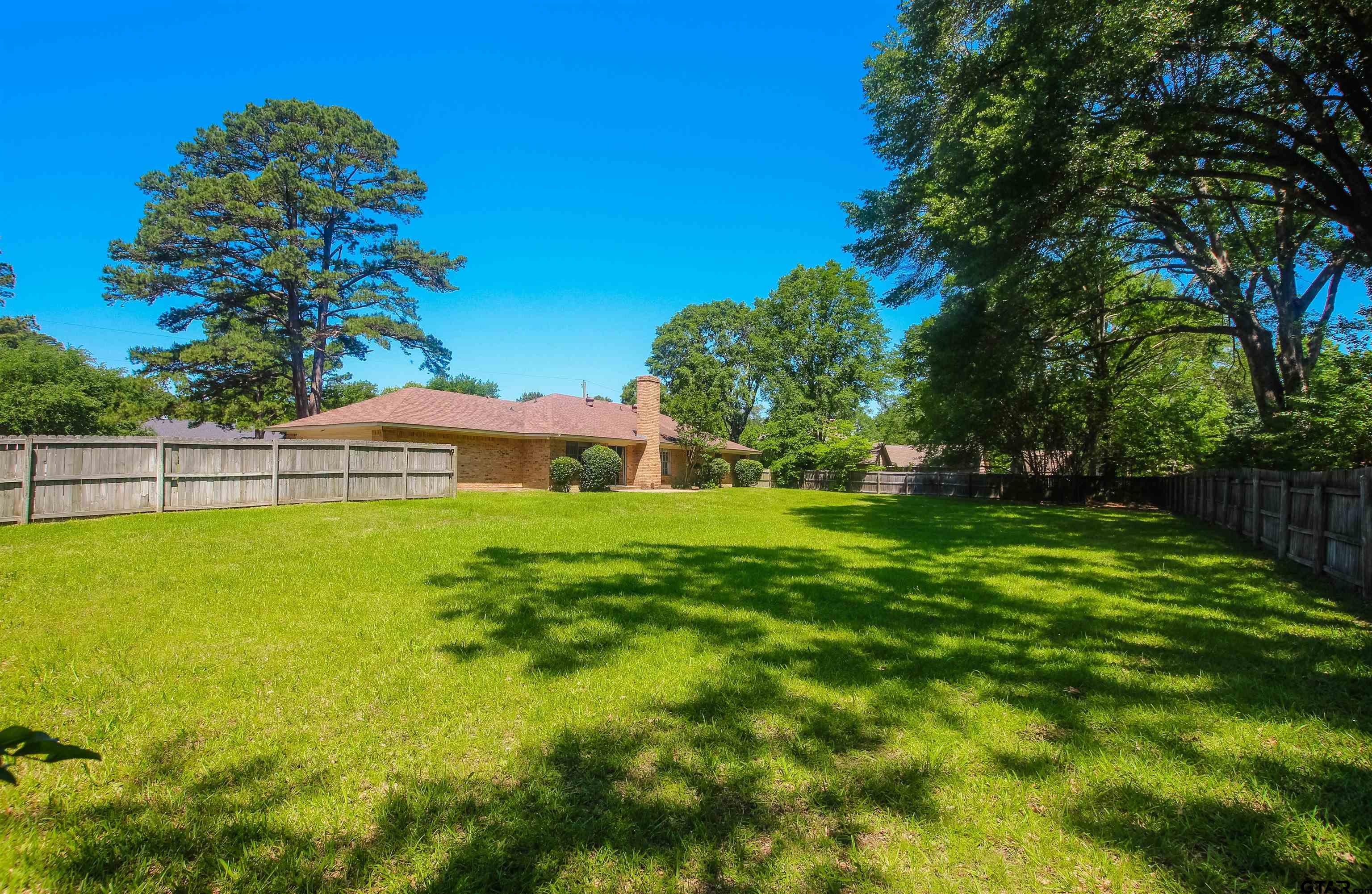 8524 Radcliffe Drive Tyler, TX 75703 - Photo 24 of 26 a view of yard with swimming pool and green space