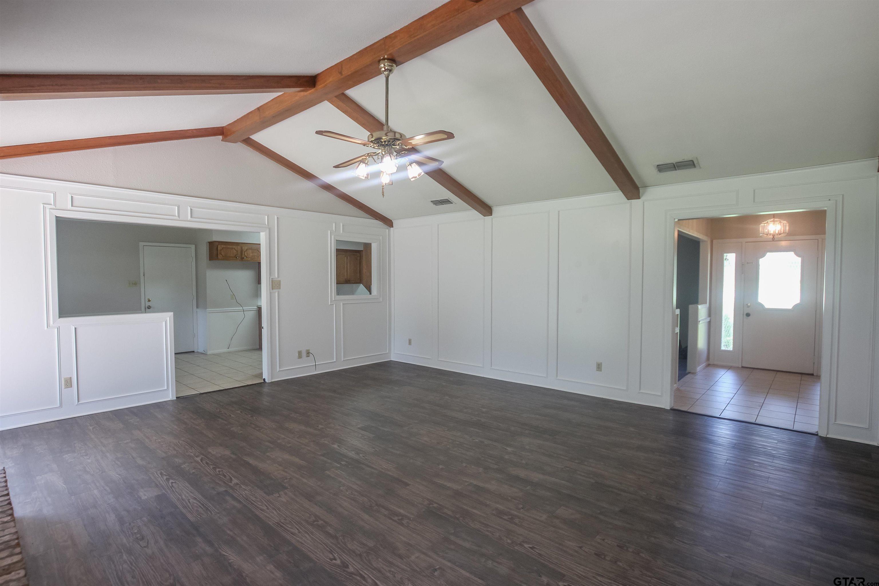 8524 Radcliffe Drive Tyler, TX 75703 - Photo 5 of 26 an empty room with wooden floor fan and windows