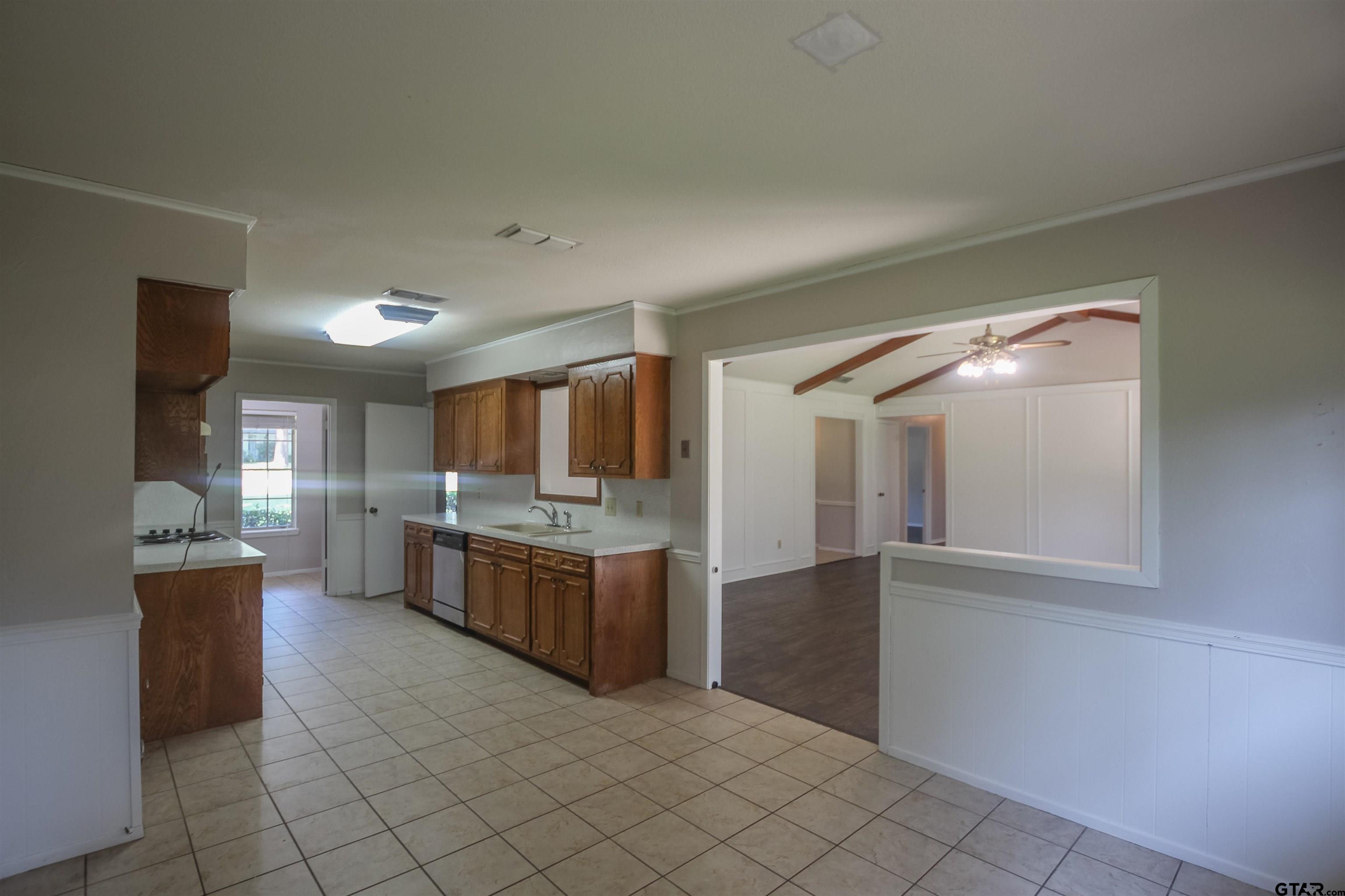 8524 Radcliffe Drive Tyler, TX 75703 - Photo 8 of 26 a kitchen with stainless steel appliances granite countertop a refrigerator and a stove top oven