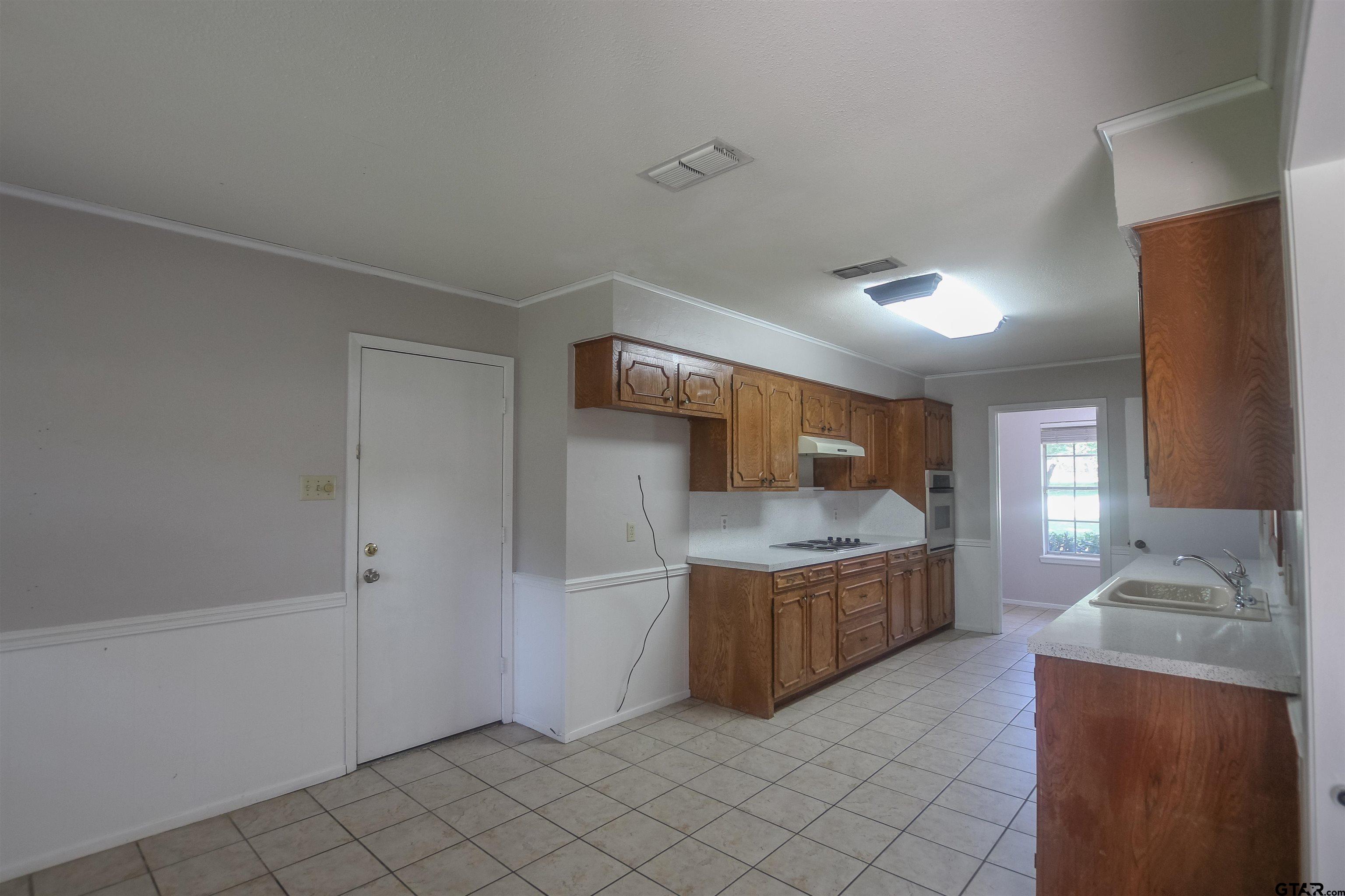 8524 Radcliffe Drive Tyler, TX 75703 - Photo 9 of 26 a kitchen with stainless steel appliances granite countertop a sink and a stove top oven