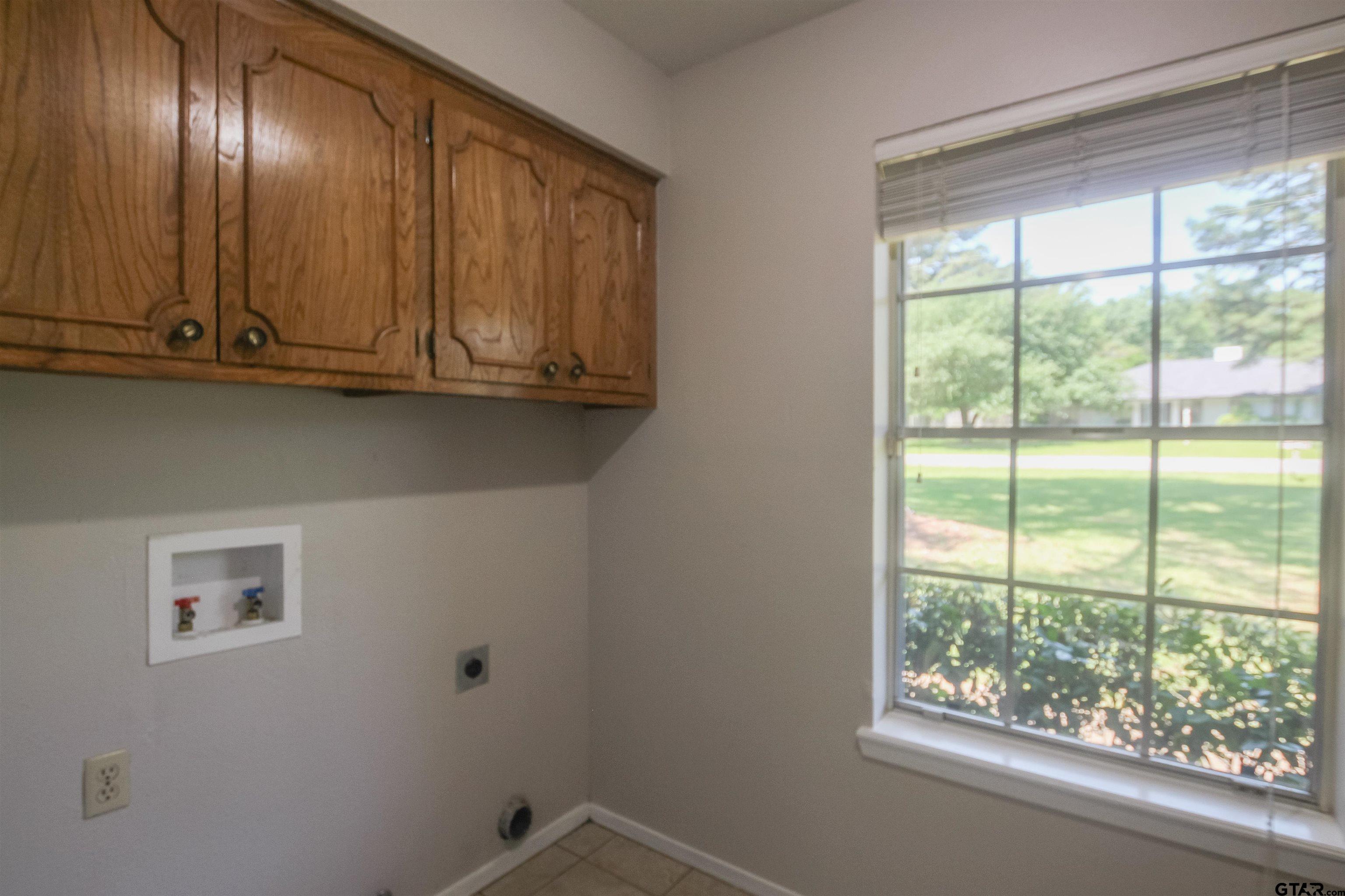 8524 Radcliffe Drive Tyler, TX 75703 - Photo 10 of 26 a view of an empty room with wooden floor and windows