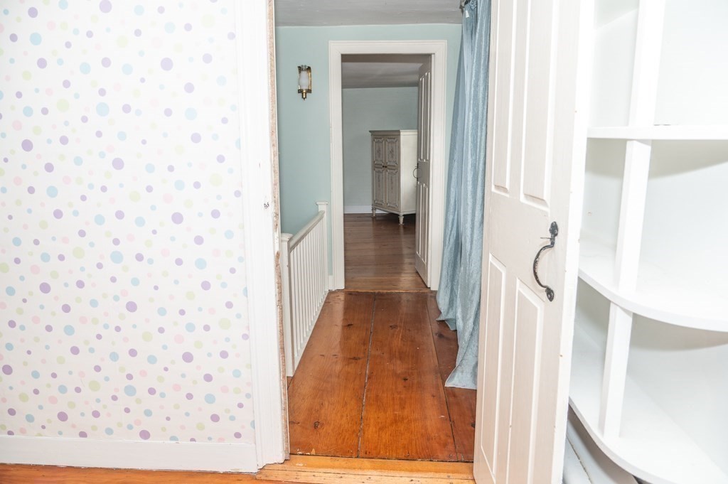 167 Elm Street Hanover, MA 02339 - Photo 17 of 26 a view of a hallway with wooden floor and staircase