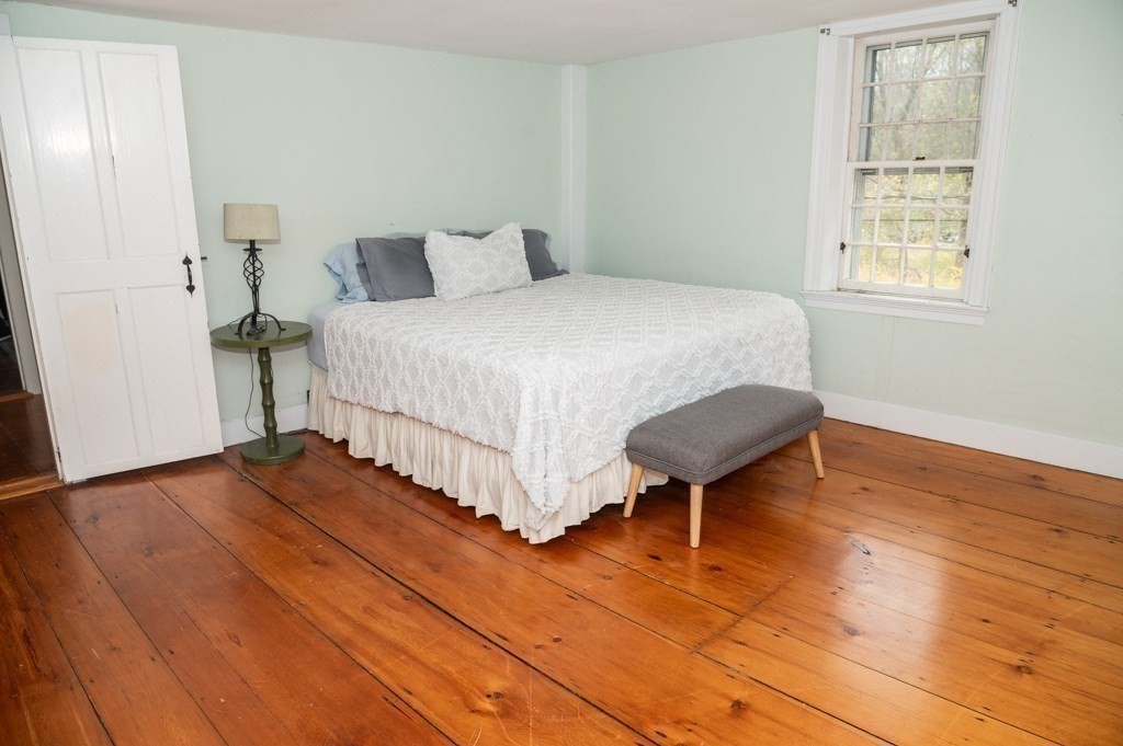 167 Elm Street Hanover, MA 02339 - Photo 18 of 26 a bedroom with a bed and a chair