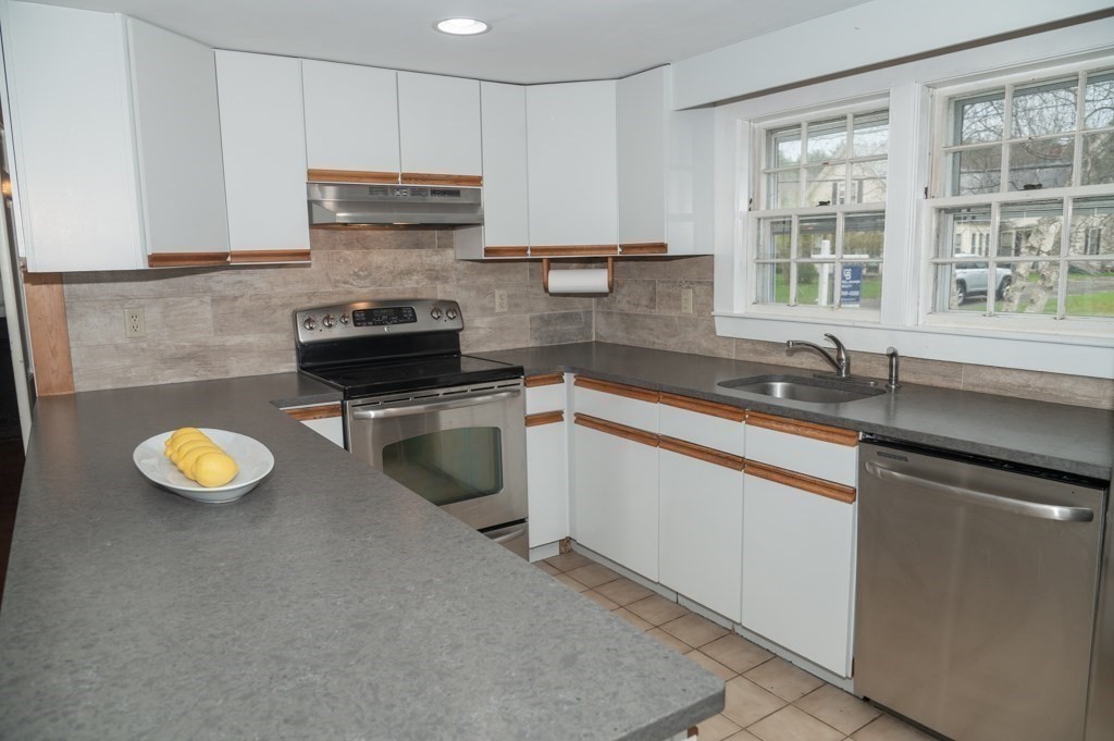 167 Elm Street Hanover, MA 02339 - Photo 3 of 26 a kitchen with a sink a stove and cabinets
