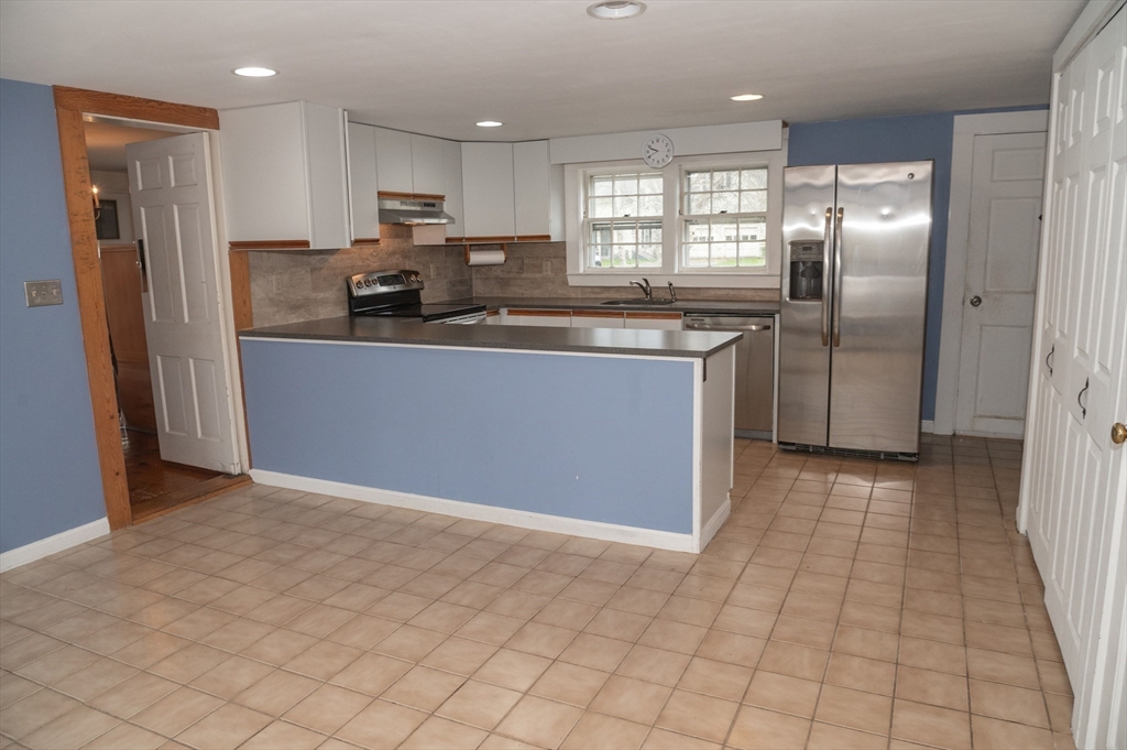 167 Elm Street Hanover, MA 02339 - Photo 4 of 26 a kitchen with stainless steel appliances granite countertop a refrigerator and a sink