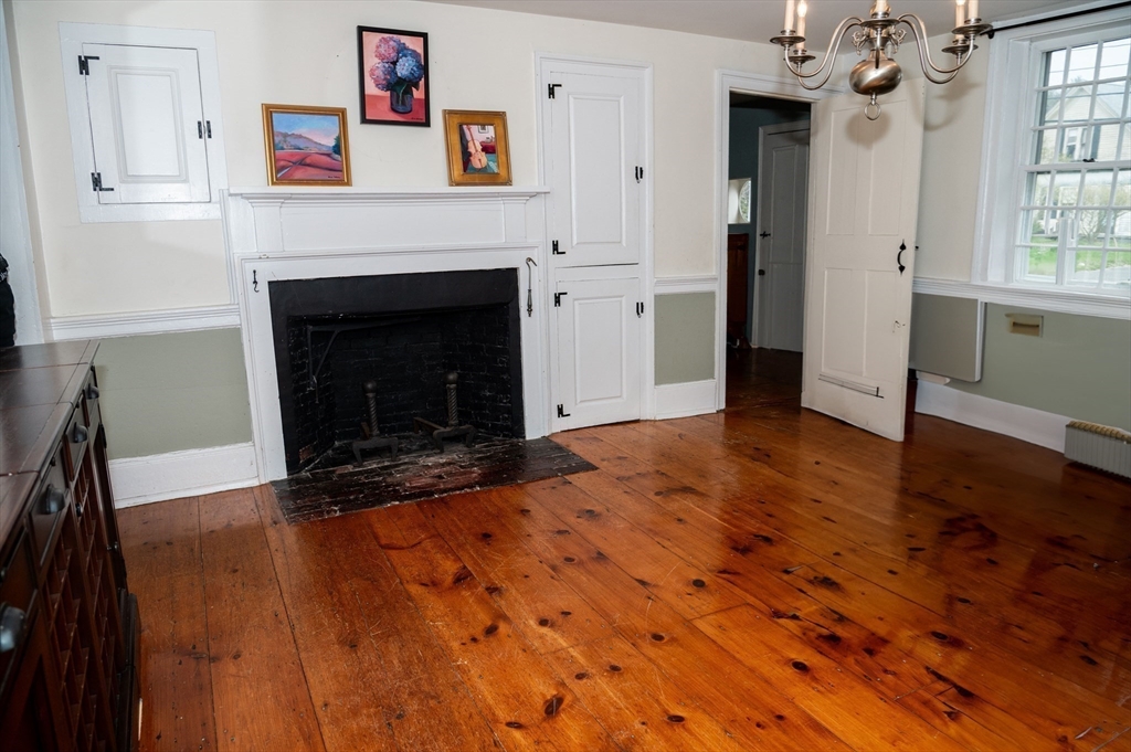 167 Elm Street Hanover, MA 02339 - Photo 6 of 26 wooden floor fireplace and windows in an empty room