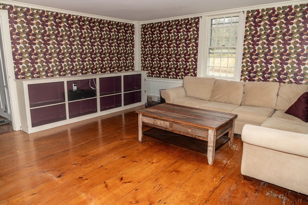 167 Elm Street Hanover, MA 02339 - Photo 8 of 26 a living room with furniture a window and a fireplace