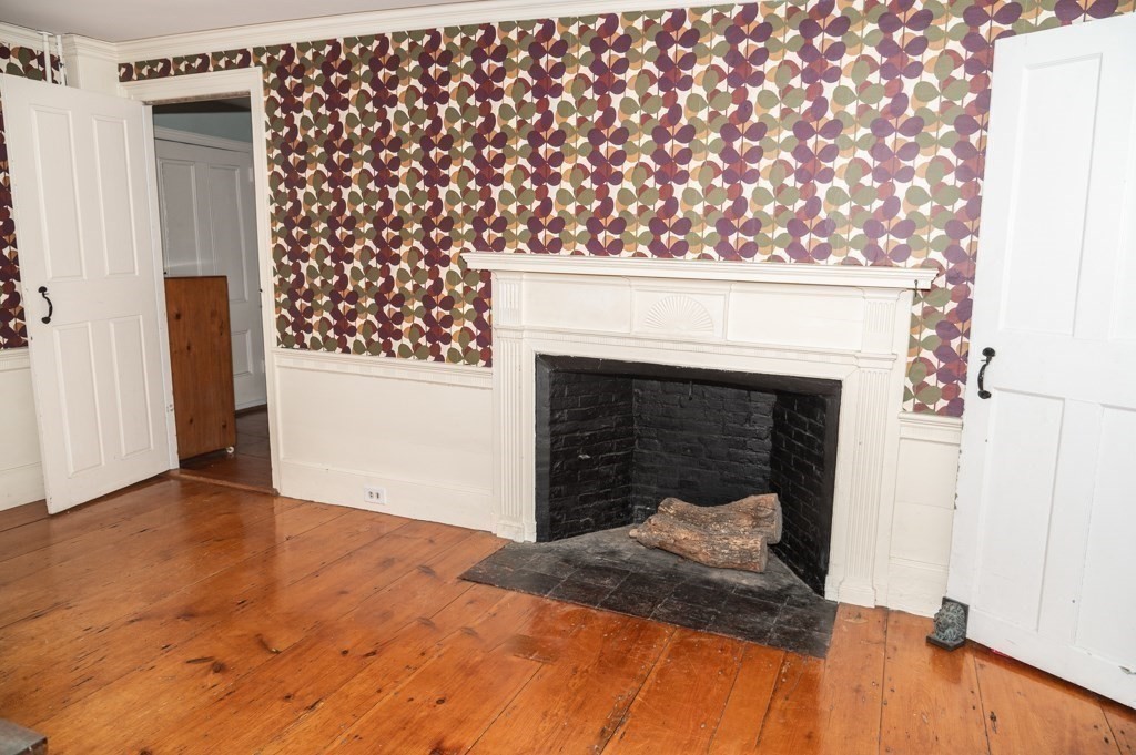 167 Elm Street Hanover, MA 02339 - Photo 9 of 26 a bedroom with a bed and a fireplace