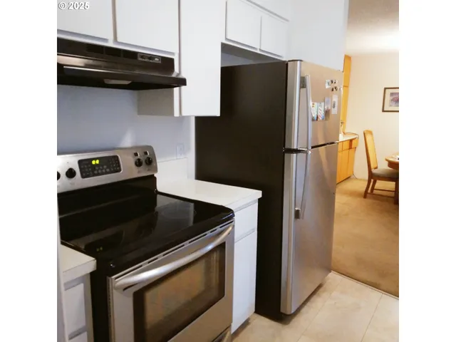 a kitchen with a stove and a refrigerator