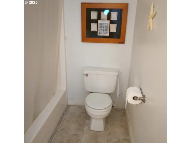 a white toilet sitting next to a small bathroom