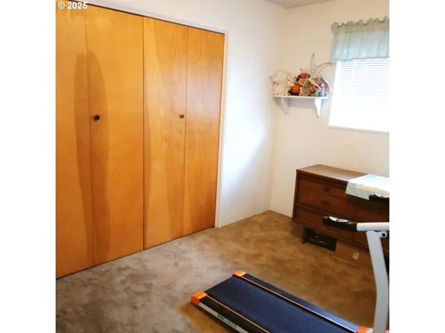 a bedroom with a bed and a hallway