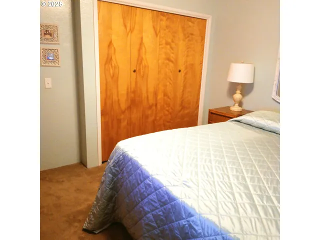 a bedroom with a bed and a lamp