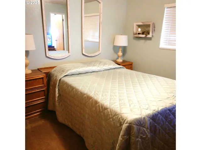 a bedroom with a bed and a mirror