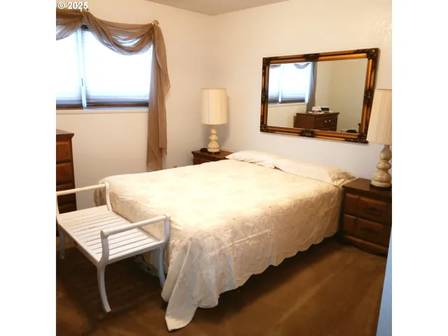 a bed room with a bed and a mirror