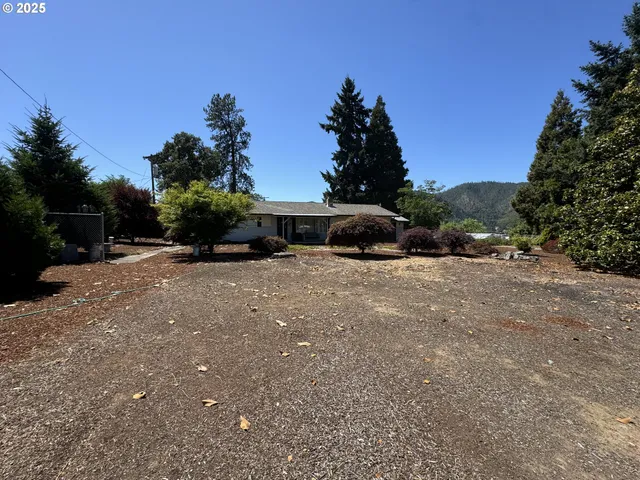 a view of a house with a yard and sitting area