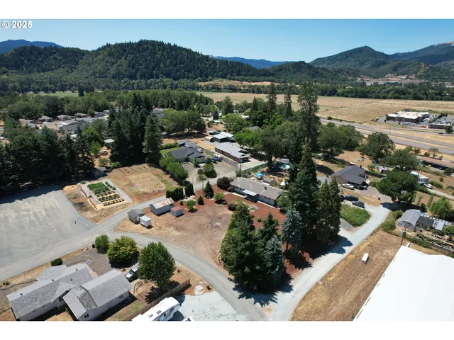 an aerial view of residential house with outdoor space and river